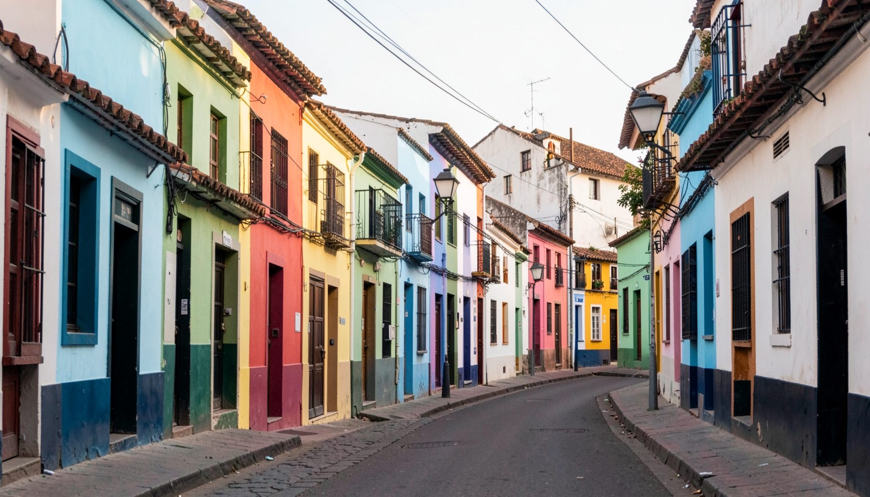 Colourful Portuguese-style buildings lining a quiet Panjim street in soft morning light
